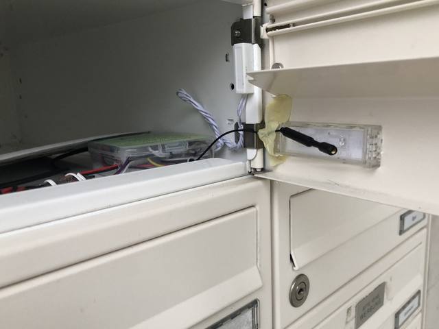 Installed inside the mailbox, antenna poking out next to the flap